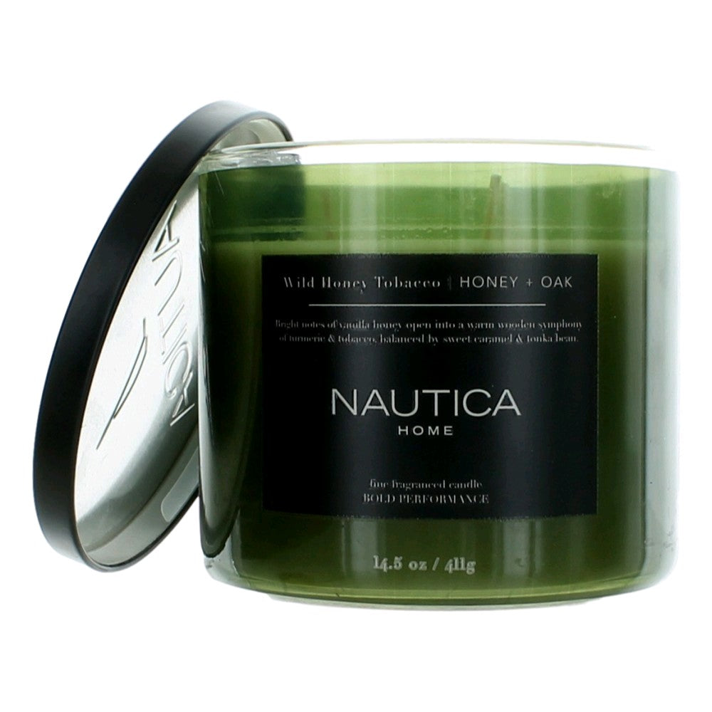 Green scented candle jar labeled Wild Honey Tobacco, Honey & Oak, with metal lid