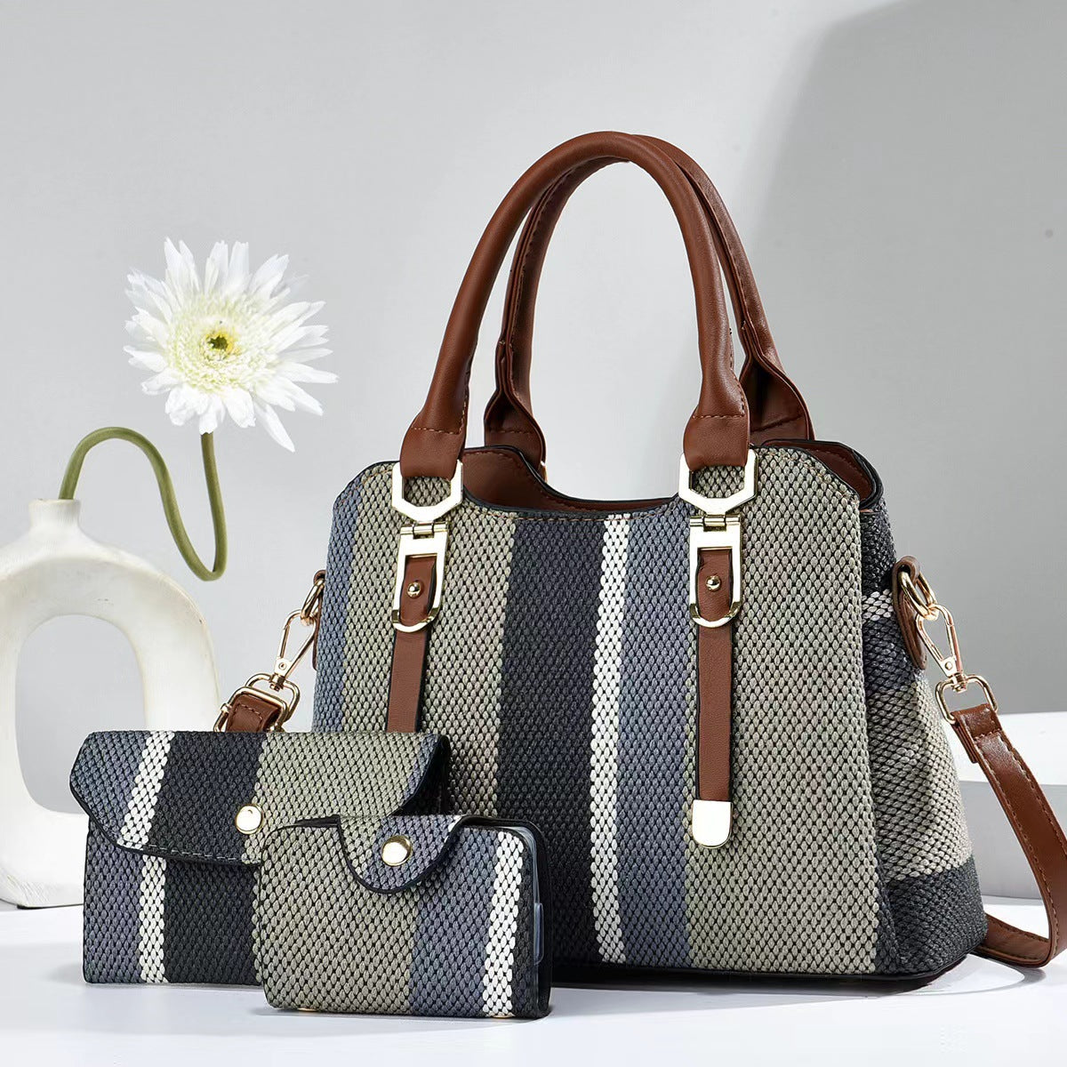Large white and blue striped canvas crossbody bag with brown handles and two accessory pouches.