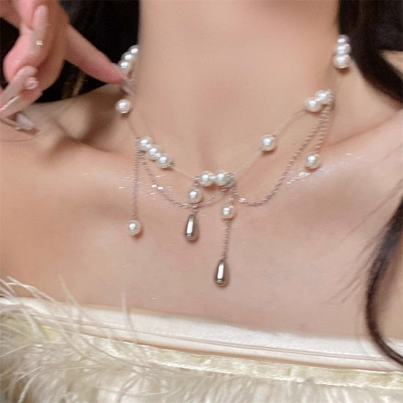 Silver-tone pearl drop necklace with small dangling bead accents