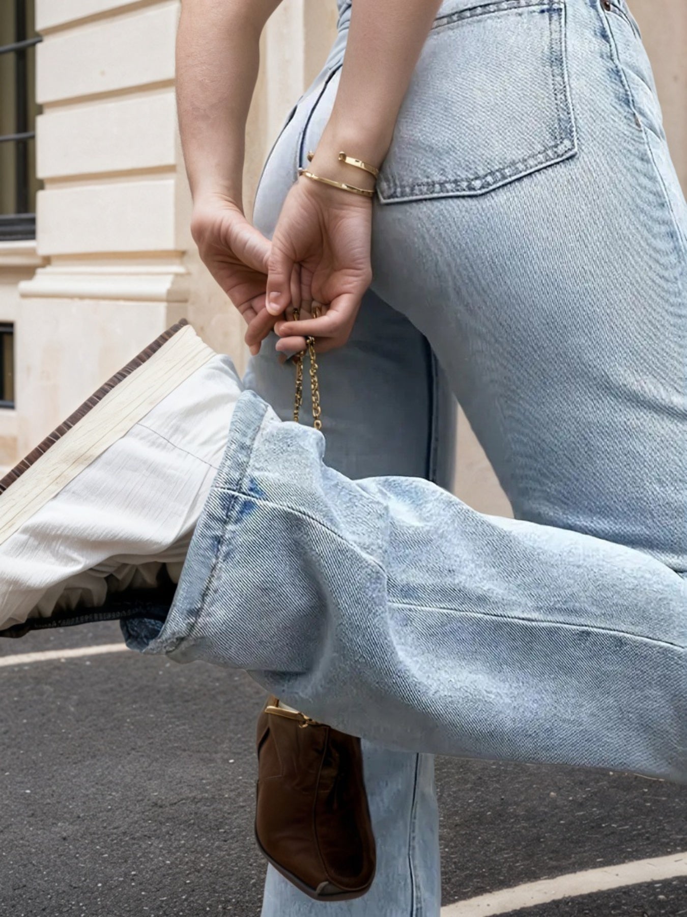 High-waisted light wash straight-leg jeans with zip fly, button closure, and pocket detail