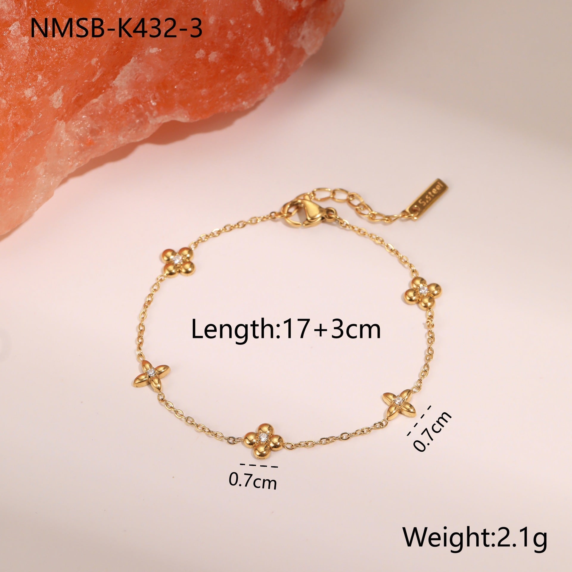 Gold-tone star charm bracelet with small crystal accents and hanging star charms