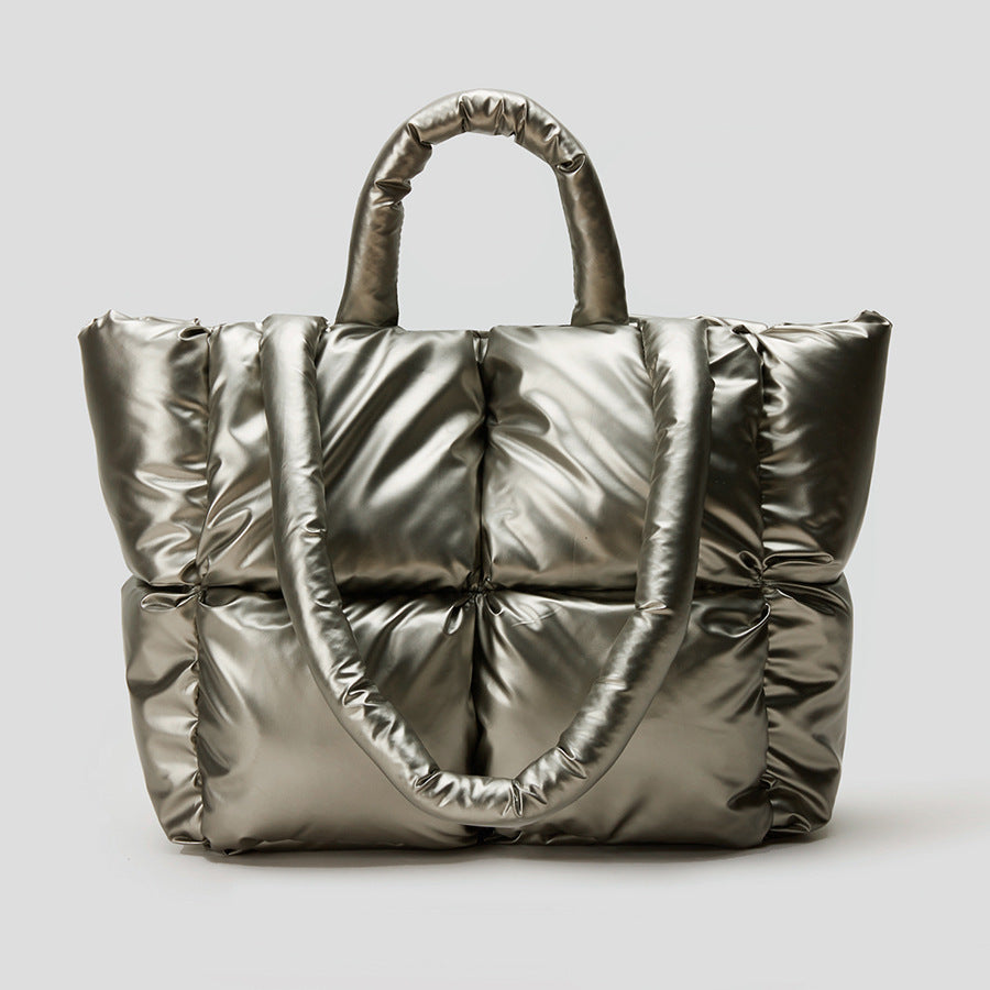 Puffer one-shoulder handbag in metallic silver with ruched quilted panels and handle loops