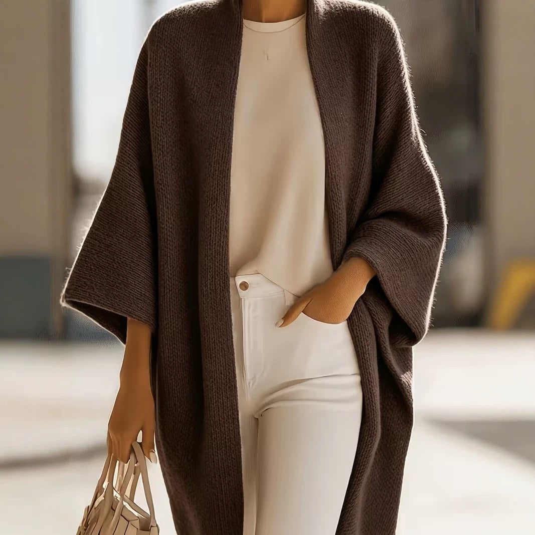 Brown knit shawl jacket with draped open front, open neckline, and short batwing sleeves