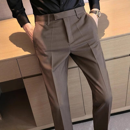 Taupe dress pants with belt loops, pleats, and front crease