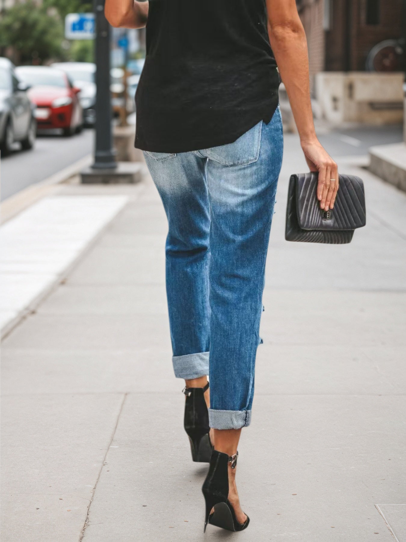 Light blue low-rise ripped jeans, ankle-cropped with raw knee rips
