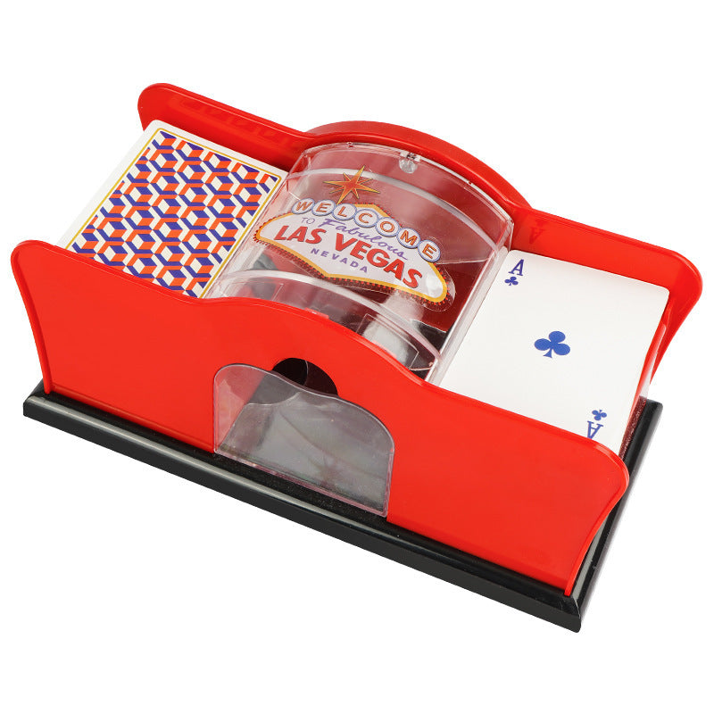 Red hand-cranked card shuffler machine with clear chamber and playing cards
