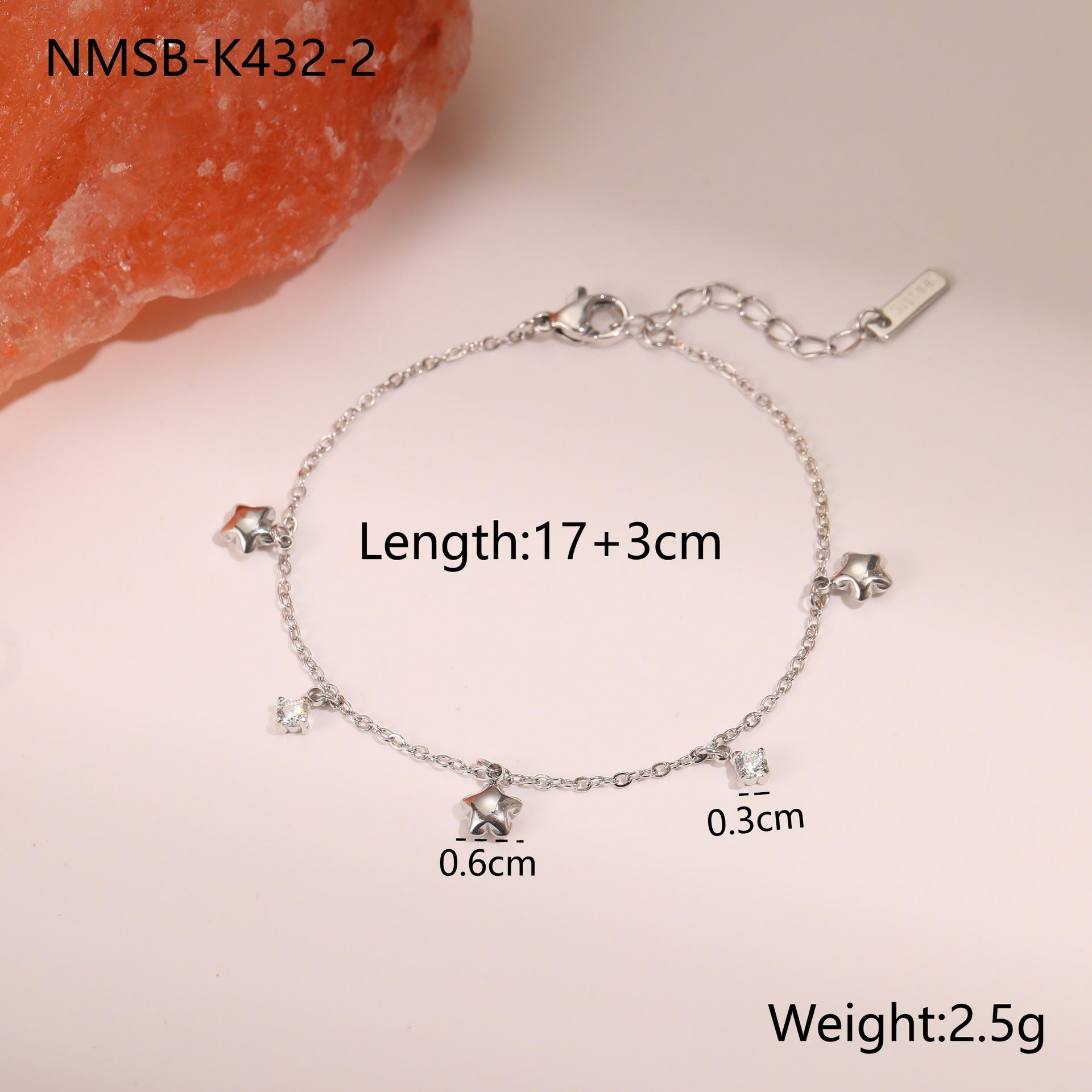 Silver-tone star charm bracelet with crystal-studded star pendants and toggle clasp