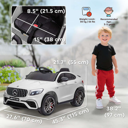 White kids 12V ride-on SUV with a child standing beside the car