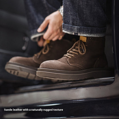 Brown suede boots with a rugged texture worn by a person sitting on a car.