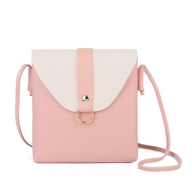 Pink messenger bag with white flap, gold ring closure, and crossbody strap