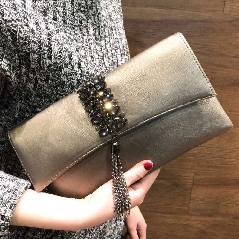 Silver grey slanted clutch with rhinestone clasp and long beaded tassel chain