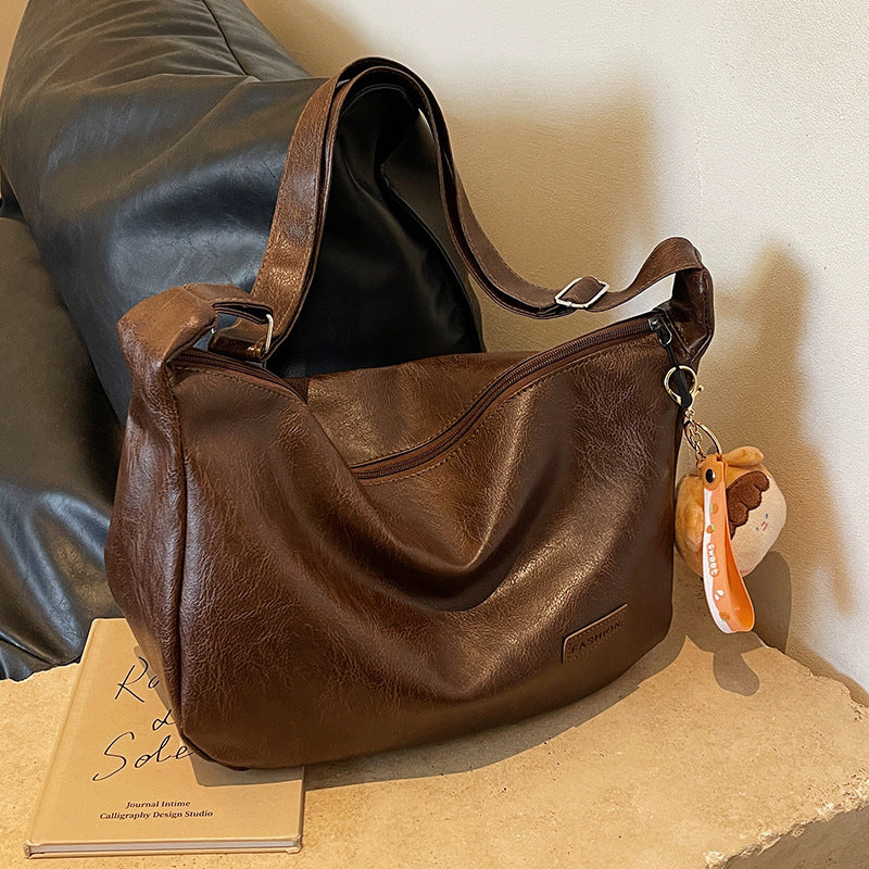 Dark brown hobo shoulder bag with shoulder strap and hanging keychain charm