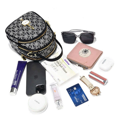 Black patterned mini shoulder bag with gold-tone hardware and heart-shaped charm