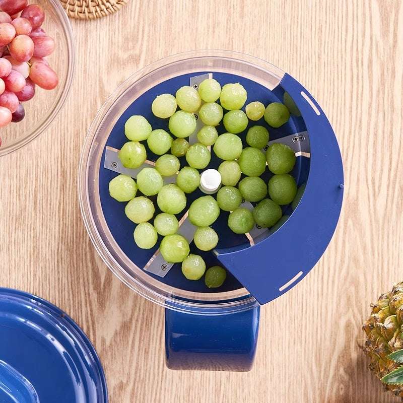Blue grape squeezer with green grapes on a wooden surface