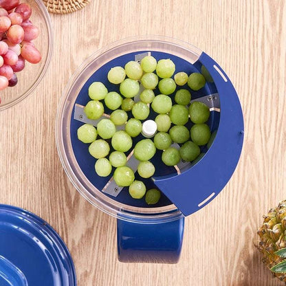 Blue grape squeezer with green grapes on a wooden surface