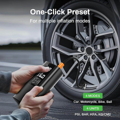 Black tire inflator held in hand with orange nozzle near car wheel and digital display