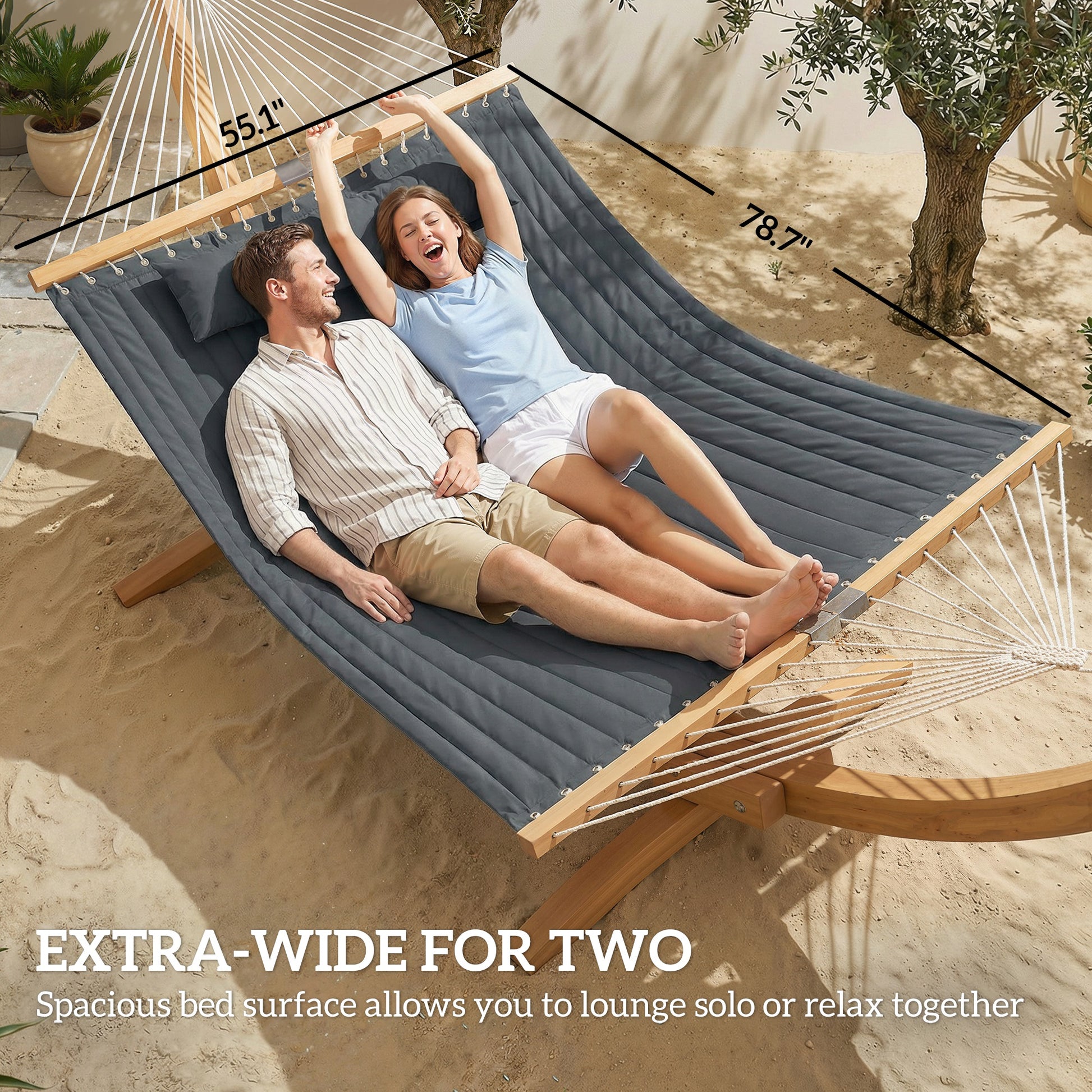 Gray extra-wide hammock for two with pillow, both people reclining on the padded surface