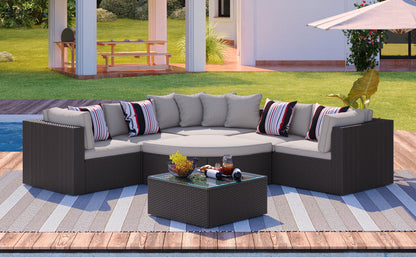 Brown wicker patio sectional sofa set with light gray cushions and glass center table