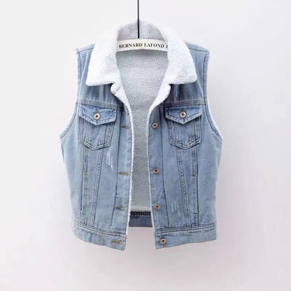 Denim vest with white fur lining on a hanger against a white background