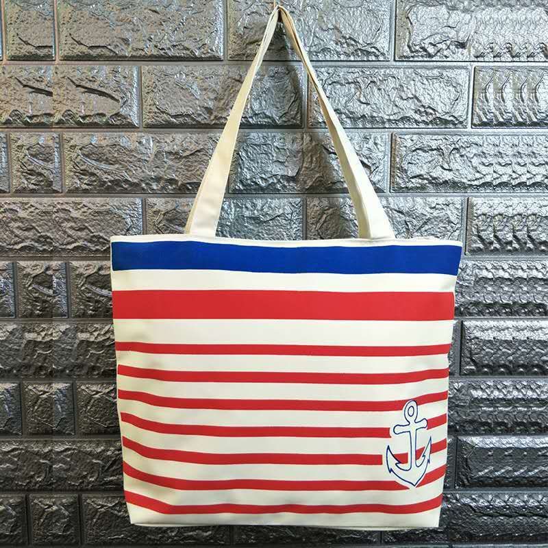 Canvas shoulder bag with red and white stripes, blue top band, and anchor graphic