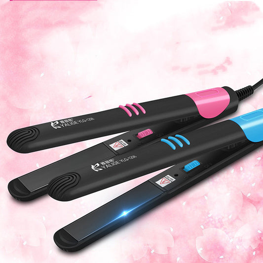 Two hair straighteners with black, pink, and blue design on a pink background