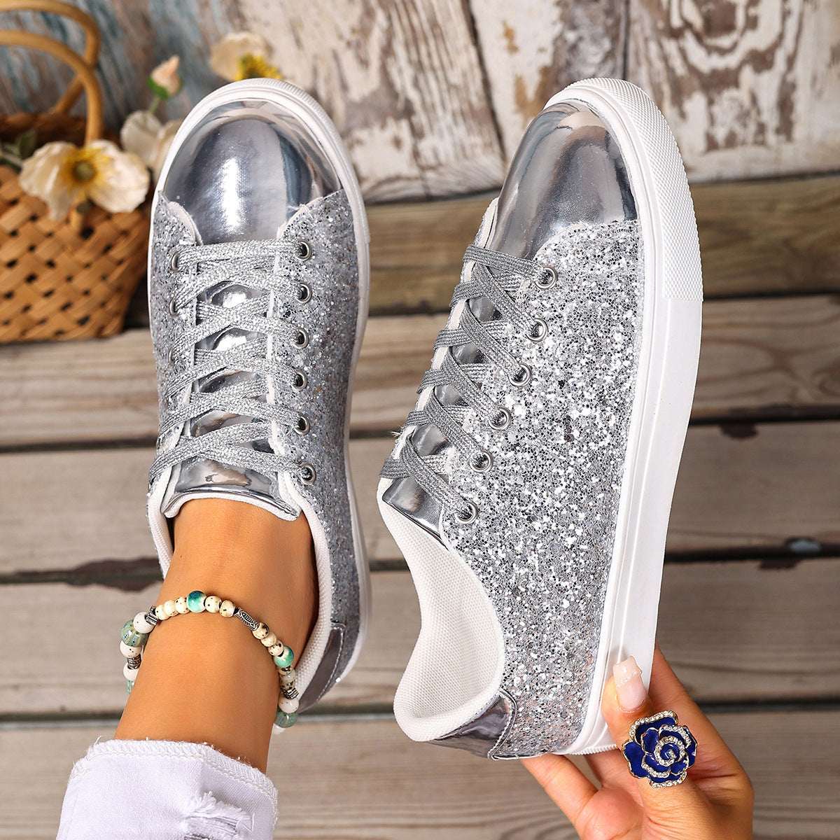 Silver sequin lace-up board shoes with white rubber sole, low profile.