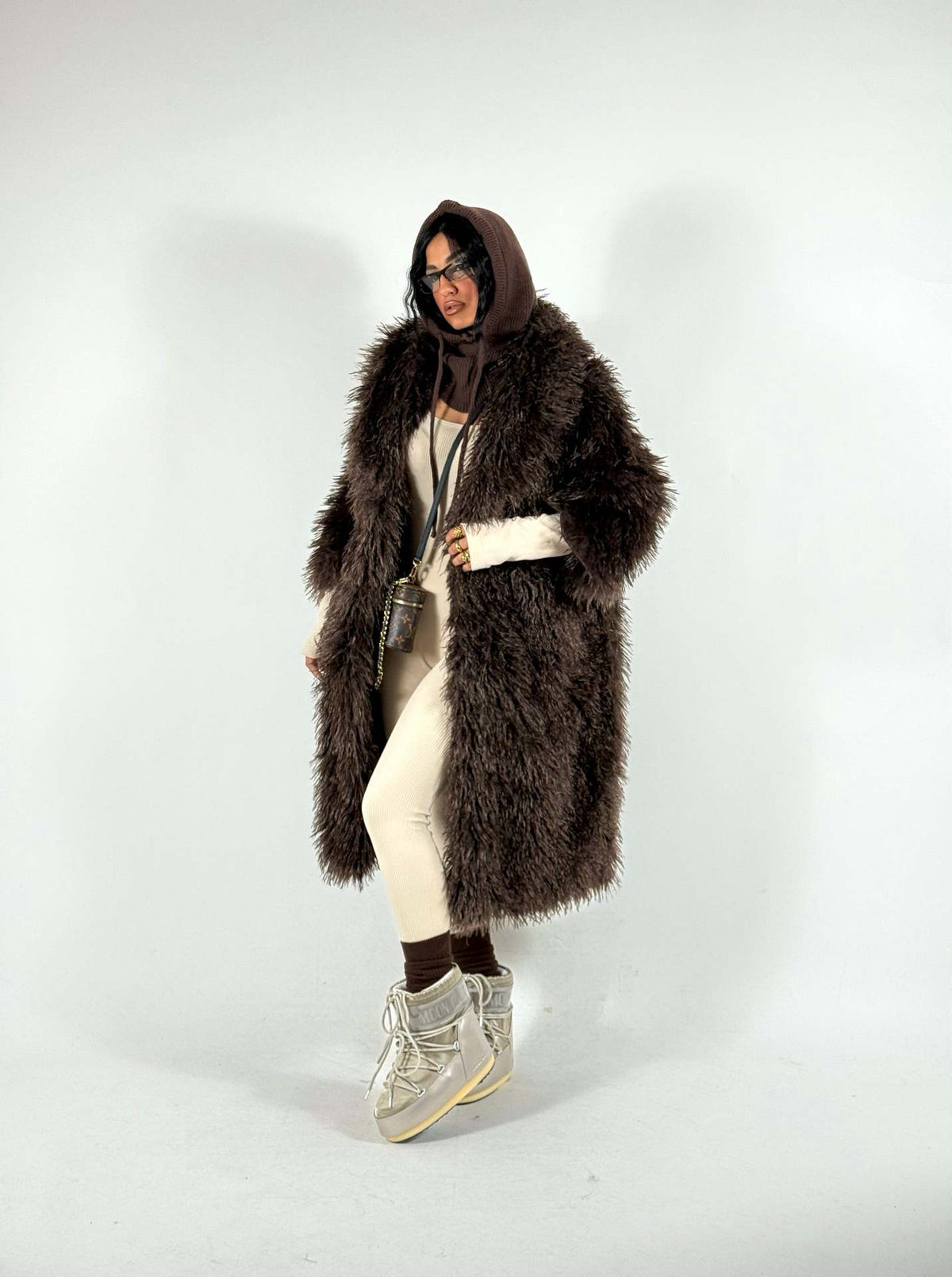 Women’s mid-length faux fur coat, dark brown/charcoal, hooded, open front, long sleeves.