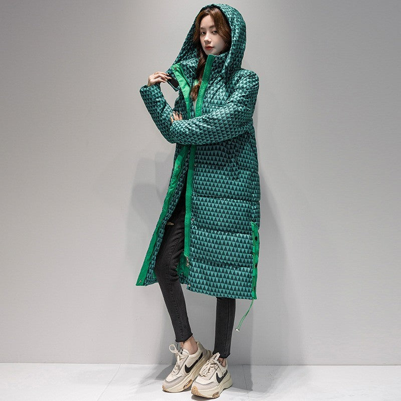 Person wearing a green quilted coat on a gray background