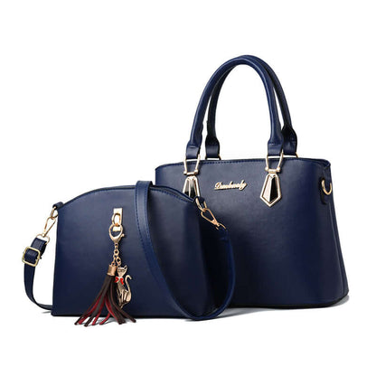 Blue faux-leather crossbody handbag with tassel charm, gold hardware, and front oval pocket
