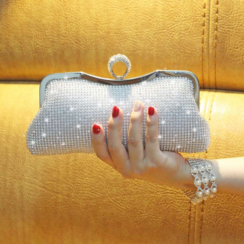 Silver rhinestone clutch with long loop handle and hinged clasp frame