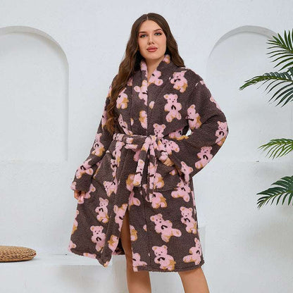 Woman wearing a brown robe with teddy bear pattern on a white background