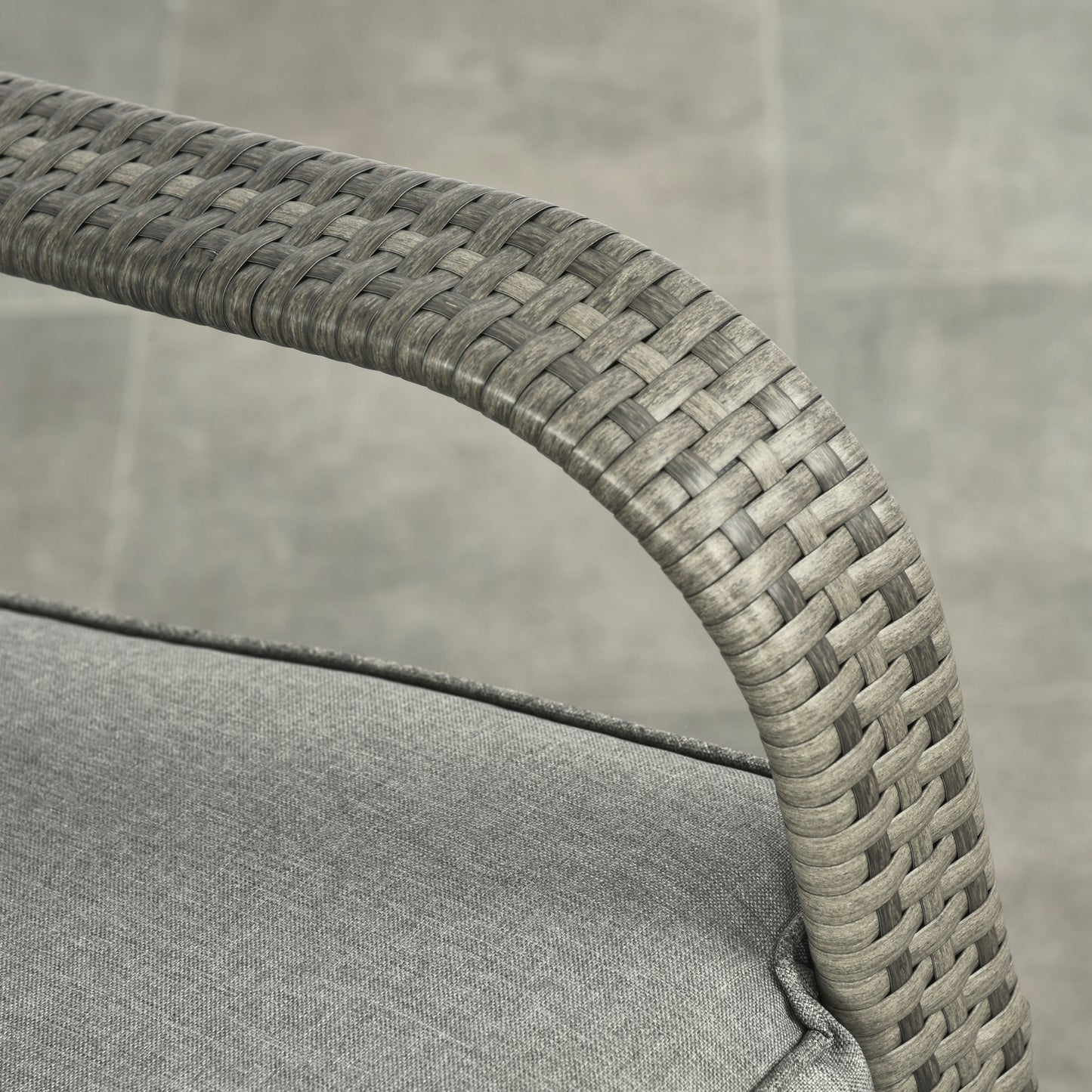 Close-up of gray woven wicker arm and rounded frame on rocking recliner