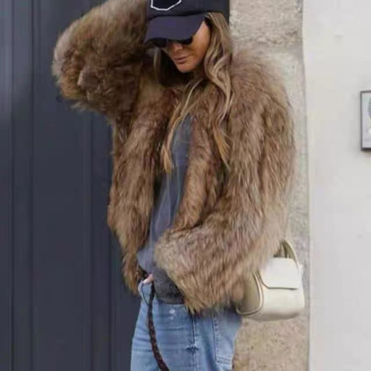 Person wearing a brown fur coat, black cap, and blue jeans with a beige handbag.
