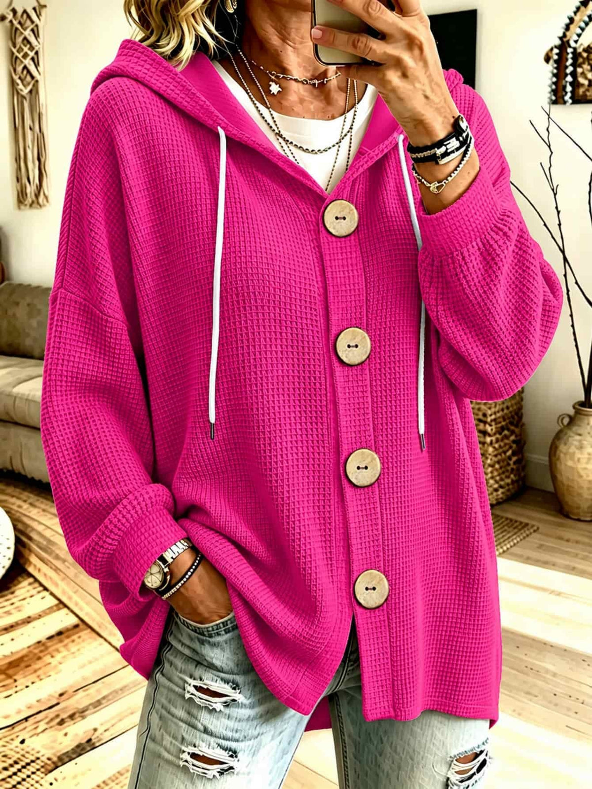 Hooded knit blouse in fuchsia with long sleeves, button placket, and drawstring ties