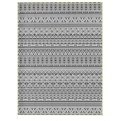 Reversible outdoor rug with black-and-white geometric pattern and fringe trim