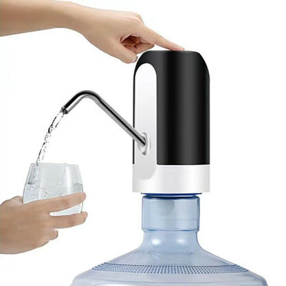 Electric water bottle dispenser in use, dispensing water into a glass