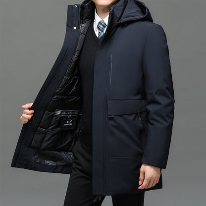 Person wearing a dark blue coat with a gray background
