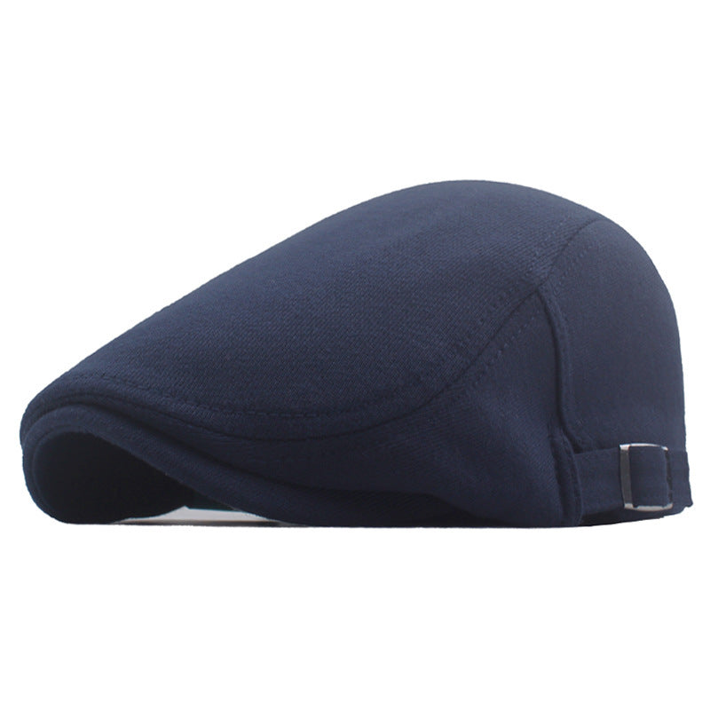 Navy blue newsboy cap with curved brim and adjustable strap, side profile