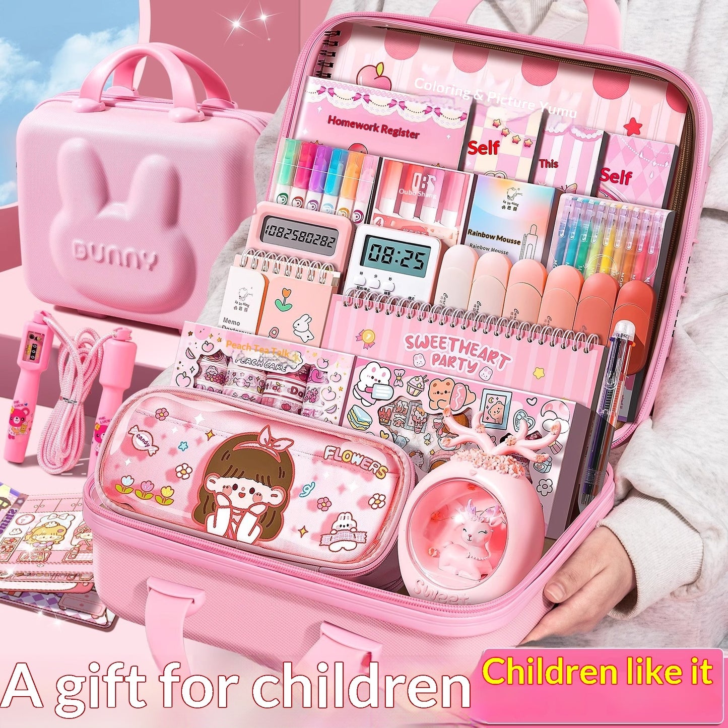 Pink stationery gift set box, open with colorful pens, stickers, and notebook pages