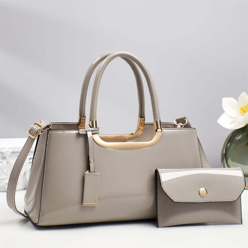 Light gray hobo shoulder bag with gold-tone handles and matching flap wallet pouch