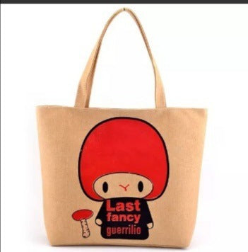 Canvas shoulder tote bag with red character print and tan top handles