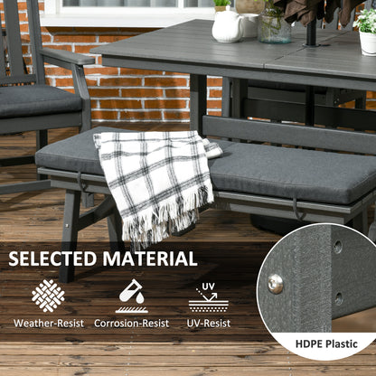 Dark gray bench seat with gray cushion and plaid throw on patio dining set table area