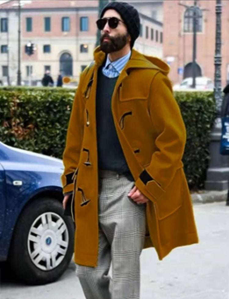 Men’s hooded wool trench coat in ginger yellow with horn-style buttons and chest flap pockets.