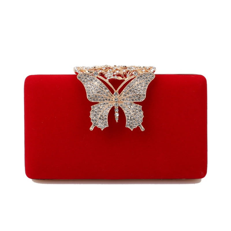Red velvet evening clutch with rhinestone butterfly clasp
