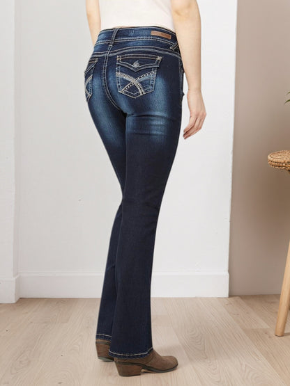 Blue embroidered pocket jeans, back view from side angle with stitched back pockets