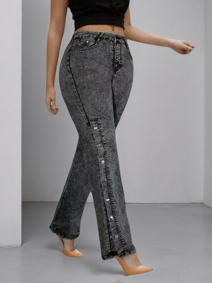 High-waisted dark jeans, slightly flared leg, side buckle accents on outer seam