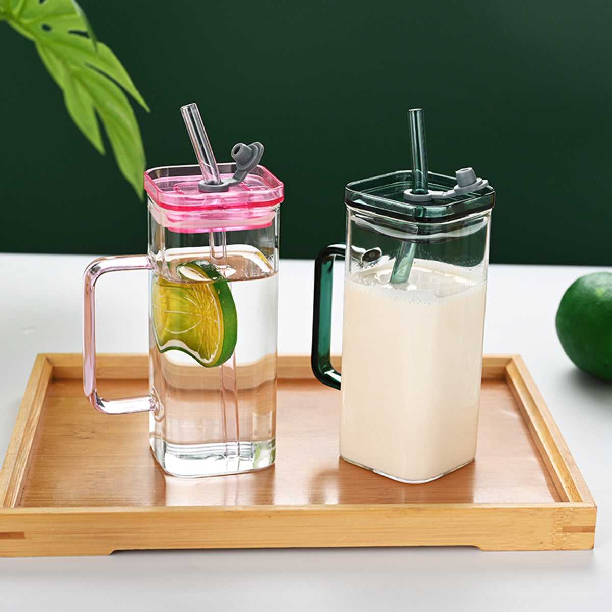Square glass cups with lids and straws, pink and green accents