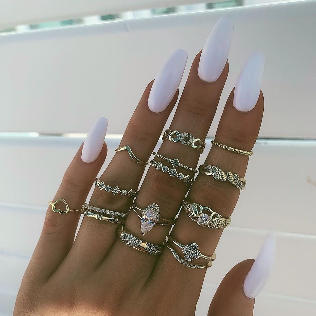 Silver-tone and gold-tone ring set with oval crystal accents, stacked bands