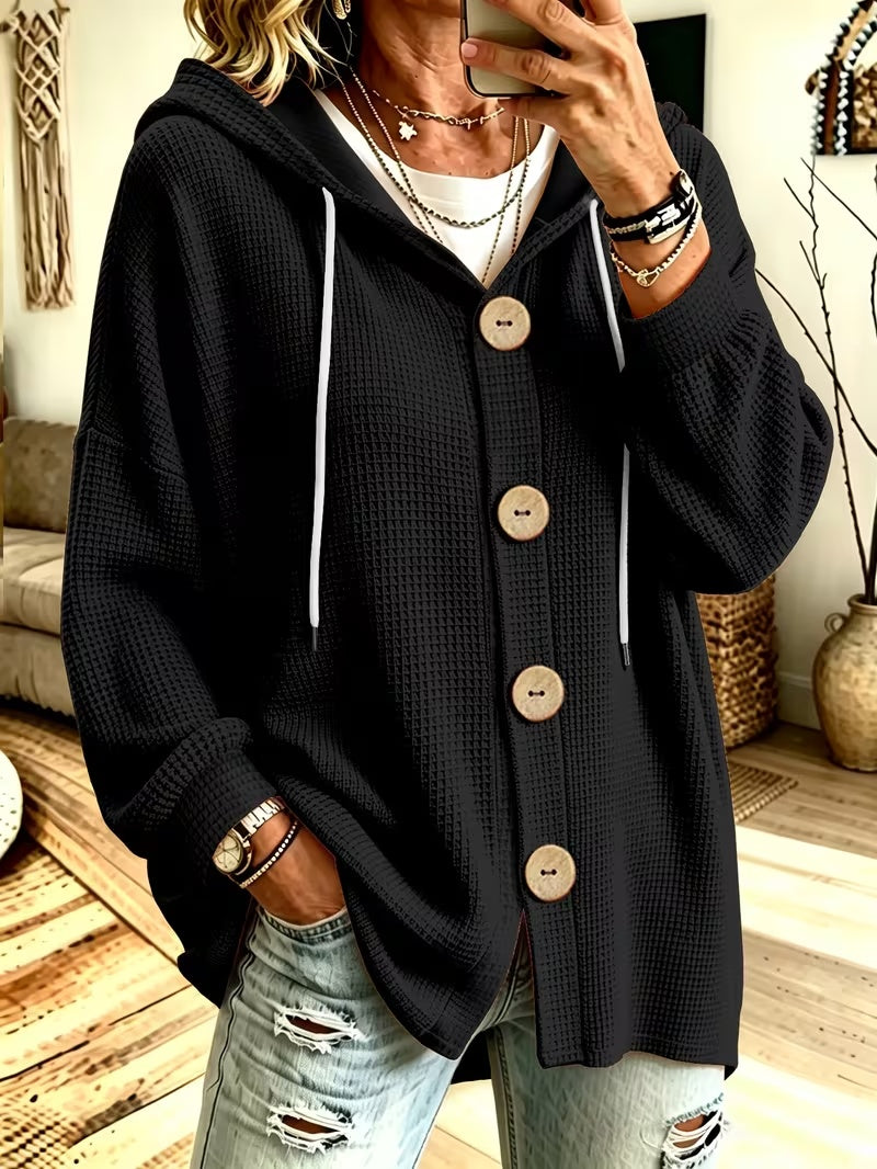 Hooded knit blouse in black with long sleeves, button placket, and drawstring ties