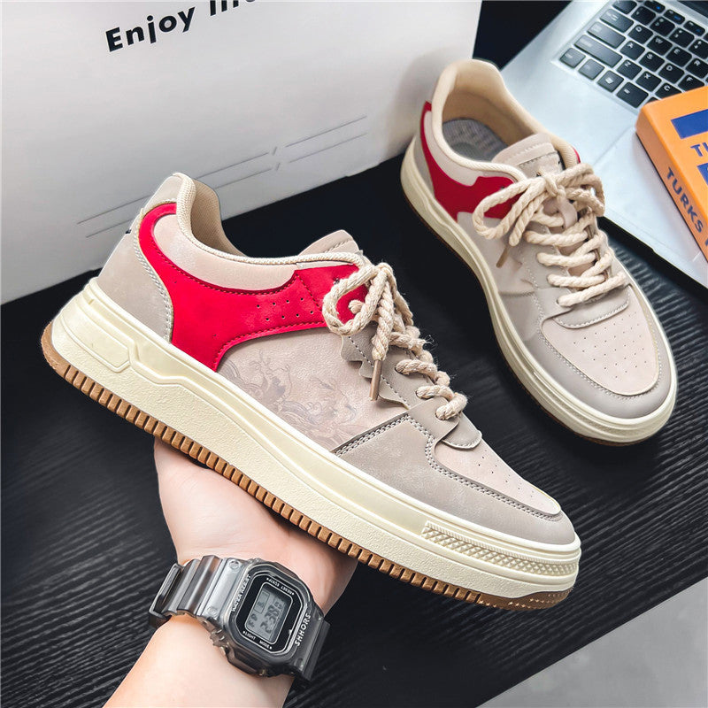 Low-top sneakers with red side suede, light gray toe, and white lace-up detail